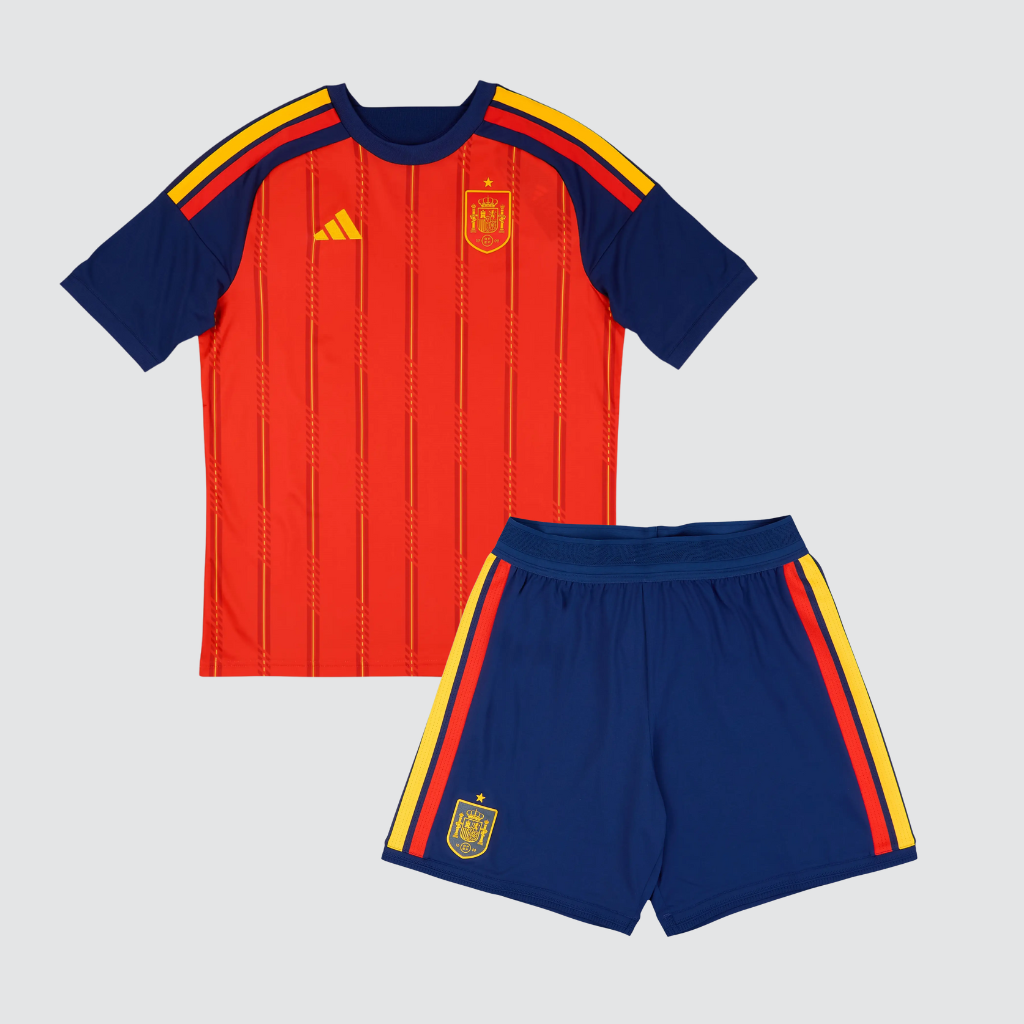 Kit infantil Espanha 2026 completo com camisa vermelha e calção azul-marinho, apresentado em fundo neutro.